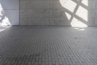 a brick floor that is on display in a room with large windows and floor tiles