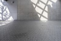 a brick floor that is on display in a room with large windows and floor tiles