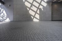 a brick floor that is on display in a room with large windows and floor tiles