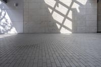 a brick floor that is on display in a room with large windows and floor tiles