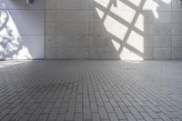 a brick floor that is on display in a room with large windows and floor tiles