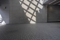 a brick floor that is on display in a room with large windows and floor tiles