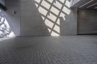 a brick floor that is on display in a room with large windows and floor tiles