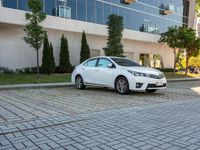 a white car is parked in the sidewalk of an office building in downtown tampa, florida