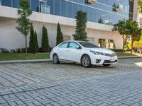 a white car is parked in the sidewalk of an office building in downtown tampa, florida