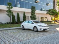 a white car is parked in the sidewalk of an office building in downtown tampa, florida