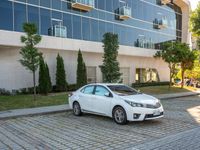 a white car is parked in the sidewalk of an office building in downtown tampa, florida