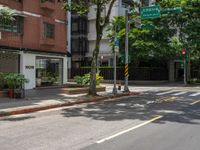 a street corner with no people walking on it and some trees on both sides of the street