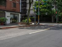 a street corner with no people walking on it and some trees on both sides of the street