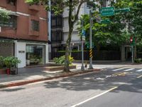 a street corner with no people walking on it and some trees on both sides of the street