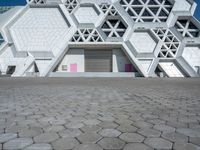 a view of a building from the ground with geometric design on it, and it looks like hexagon