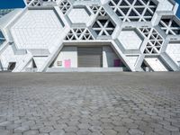 a view of a building from the ground with geometric design on it, and it looks like hexagon