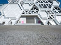 a view of a building from the ground with geometric design on it, and it looks like hexagon