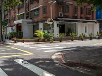 a street corner with a pedestrian crossing and a sign on the corner of it in front of a brick building