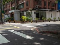 a street corner with a pedestrian crossing and a sign on the corner of it in front of a brick building