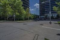 an empty empty parking lot is surrounded by tall buildings and trees in a city setting