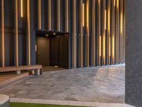 a walkway leading up to a wooden wall next to a cement area with floor tiles