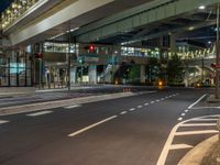 an image of outside of the night time building with the lights turned on and the streets empty