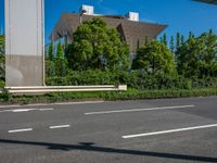 the city of richmond has long white arrows running down it's side and a pedestrian crossing over an expressway