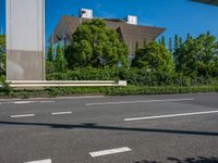 the city of richmond has long white arrows running down it's side and a pedestrian crossing over an expressway