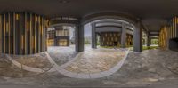 a view of a building through three panes of glass and wood on an outside walkway