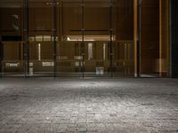 an open door at the lobby of a modern building with glass doors on either side