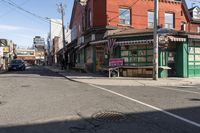 a busy intersection has shops, businesses, and other things on it in the distance