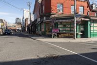 a busy intersection has shops, businesses, and other things on it in the distance