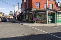 a busy intersection has shops, businesses, and other things on it in the distance