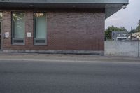 the building is made of bricks, and it is next to a street sign that says