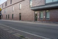 a fire hydrant is sitting in the front of a large building near an entrance way