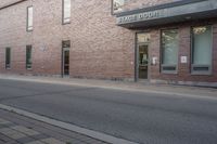 a fire hydrant is sitting in the front of a large building near an entrance way