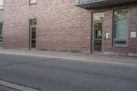 a fire hydrant is sitting in the front of a large building near an entrance way