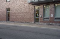 a fire hydrant is sitting in the front of a large building near an entrance way