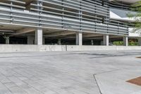 an empty parking garage has been added to the concrete structure as well as a parking lot for cars