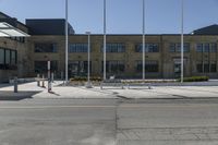 a fire hydrant sitting in front of a large building filled with flags and american flags