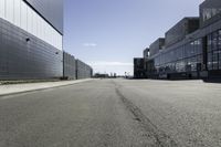 empty city street with buildings on either side of it and a blue sky above them