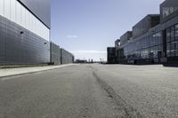 empty city street with buildings on either side of it and a blue sky above them