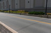 a person on a skateboard in the middle of a road beside a building with a sign