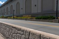 a person on a skateboard in the middle of a road beside a building with a sign