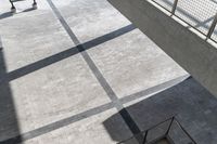 an overhead view of stairs, people and vehicles in the background as well as other buildings