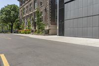a woman riding her bike down the sidewalk in front of a building that has lots of doors on the side