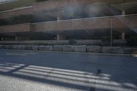 a street corner with a large parking garage in the background and a bench and chair