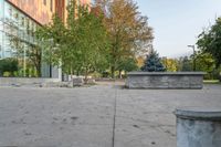 a white garbage can sitting on top of a cement floor next to a building near trees