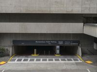 an empty parking garage in the center of a building with lots of windows and a sign