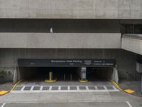 an empty parking garage in the center of a building with lots of windows and a sign