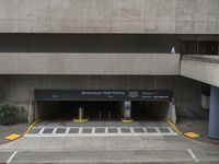 an empty parking garage in the center of a building with lots of windows and a sign