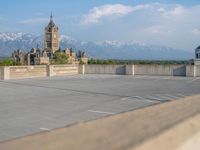 several large empty parking spaces in the city with buildings nearby in front of them -