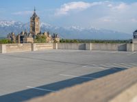 several large empty parking spaces in the city with buildings nearby in front of them -