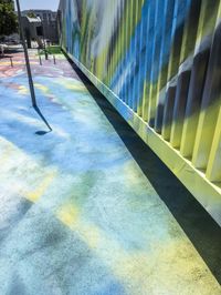 a colorful outdoor art area with some yellow and blue bars and colored painted areas along it